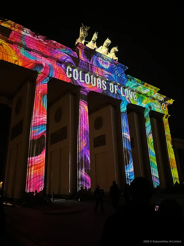 The Brandenburg Gate lit in bright colours, with the words “Colours of Love”