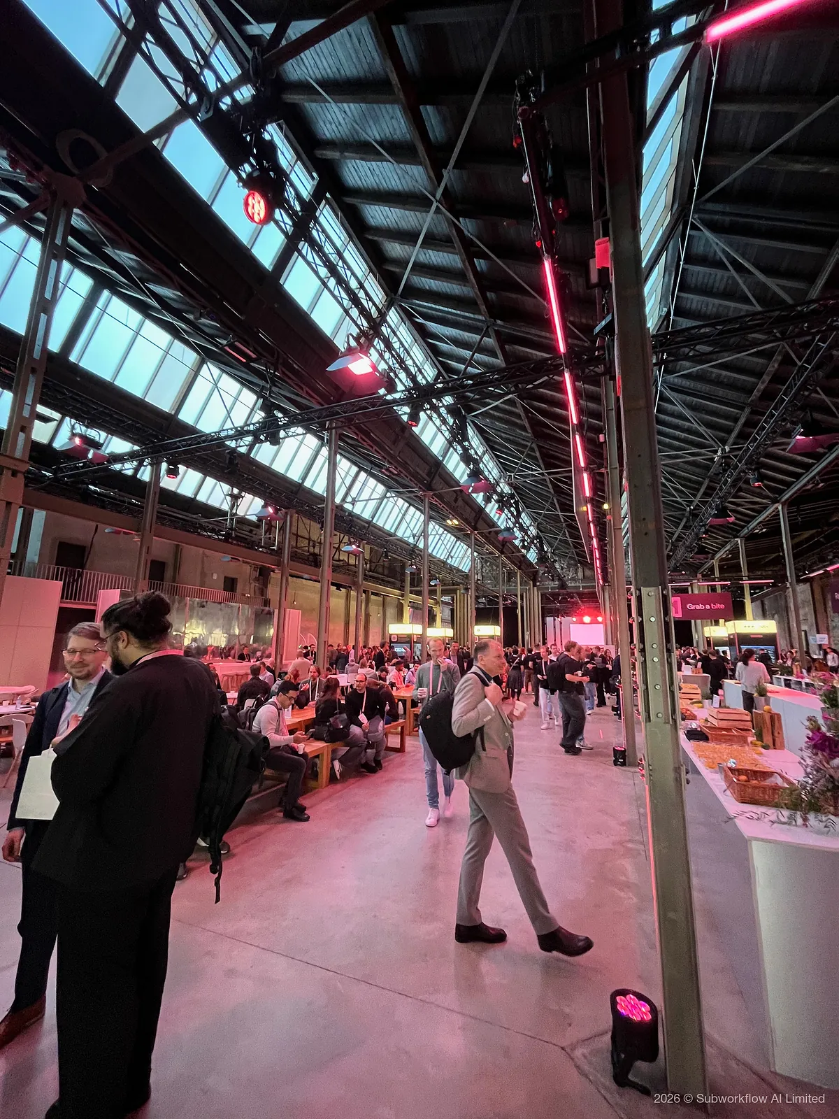 The long hall between talks, with people eating at benches