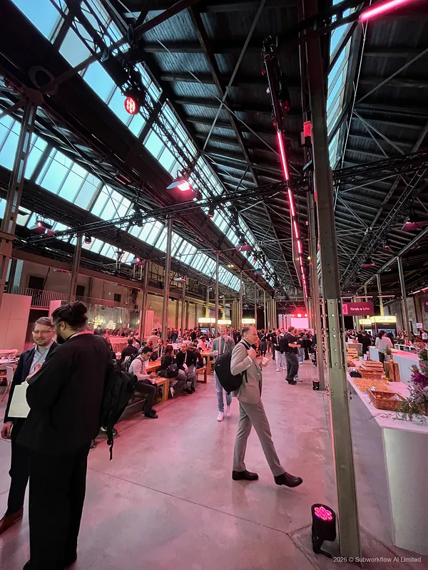 The long hall between talks, with people eating at benches