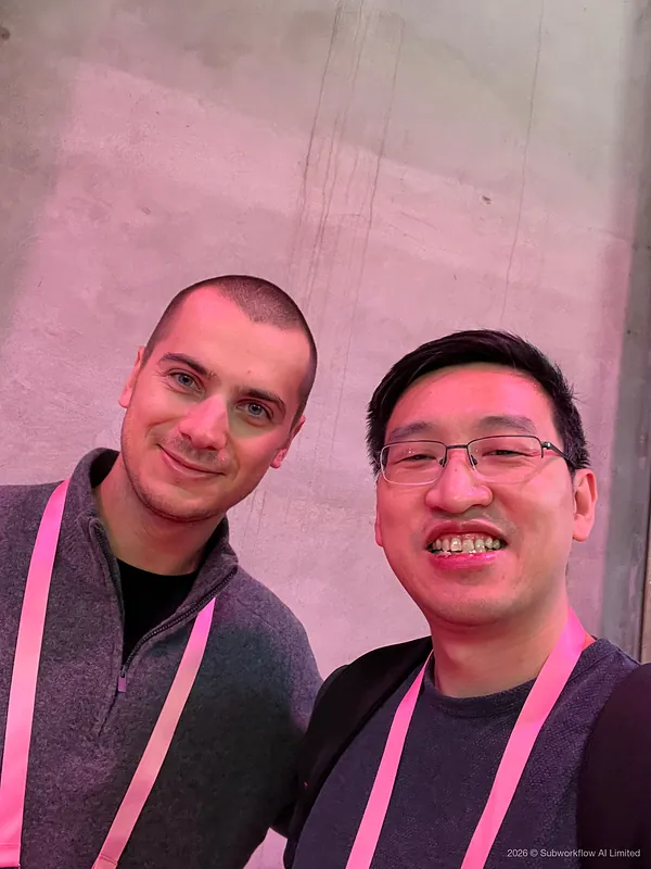 A selfie of Jim and another attendee against a concrete wall