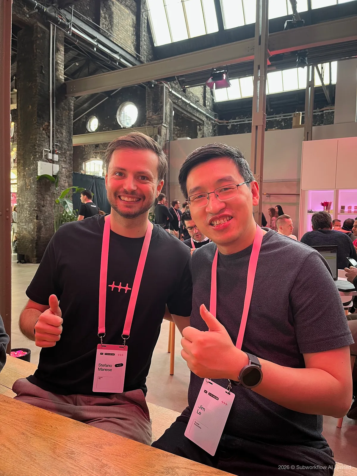 Jim and another attendee giving a thumbs up at a table