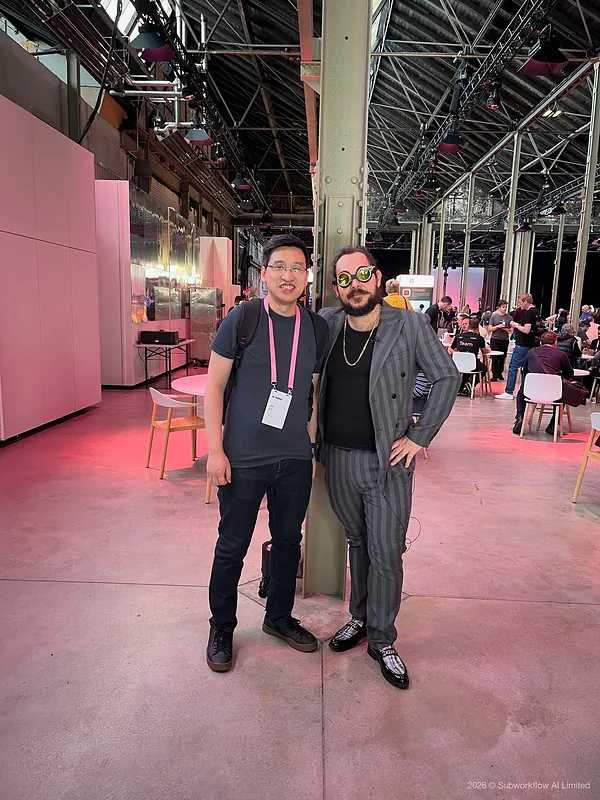 Jim with an attendee in a striped suit and goggles