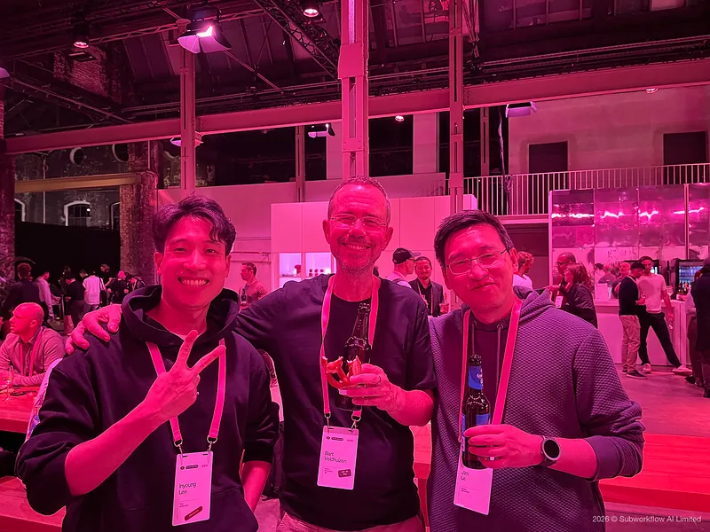Jim with two others at the evening party, one making a peace sign